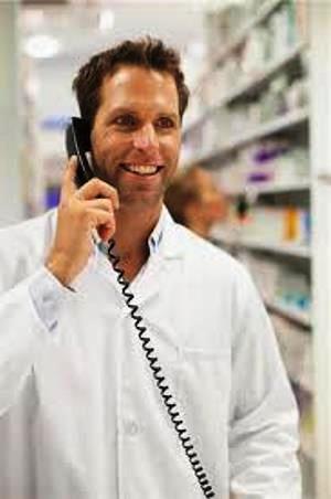 male pharmacy technician on phone with customer